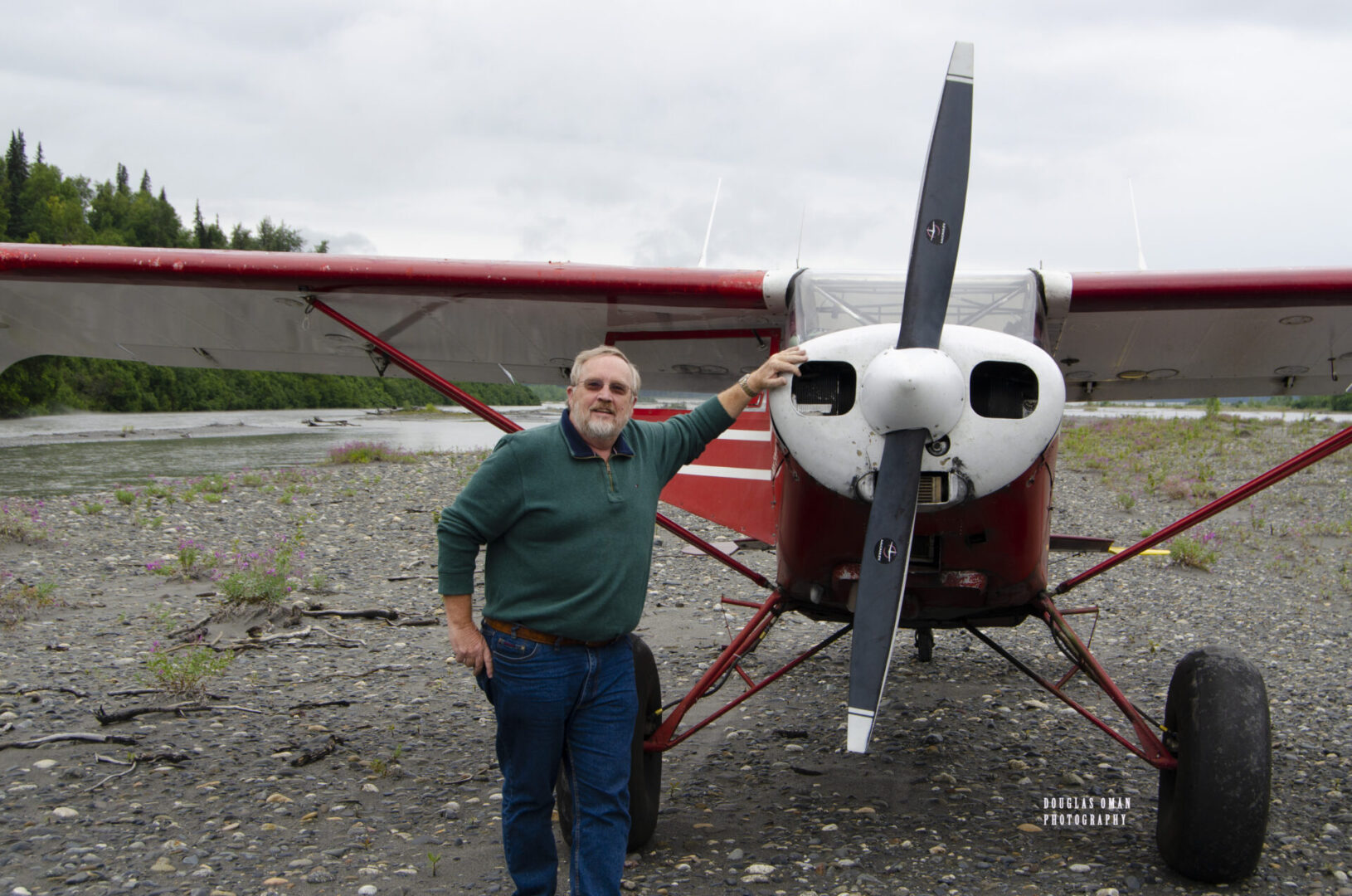 A man standing next to an airplane on the ground.