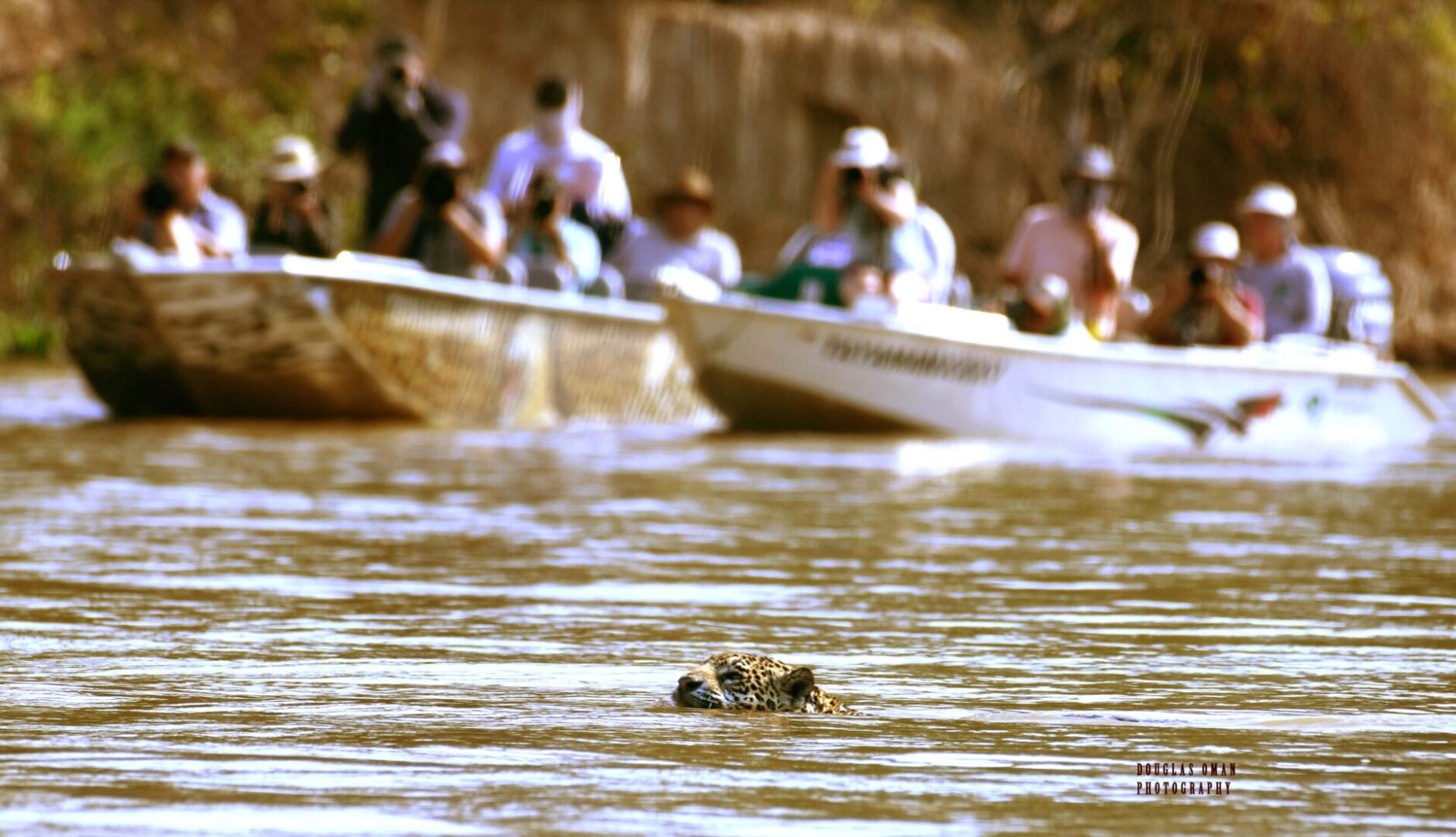 A group of people in boats on water.